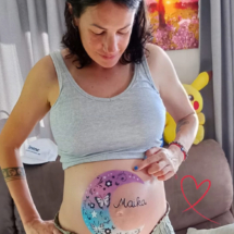 Close up of a beautifully painted baby bump, featuring moon design with delicate details. unique pregnancy belly painting in Tauranga