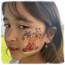 cheek face painting, reindeer with xmas lights in its antlers