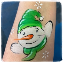 Snowman face painting, green hat and scarf on arm