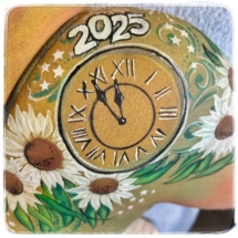 Body painting for the new years eve 2025, with flowers and a clock painted on a shoulder