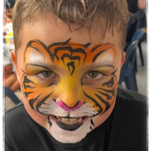 Tiger face painting on a a boy Tiger face painting on a a boy