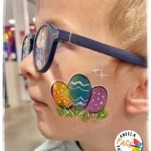 colourful Easter egg face painting on a child at a Tauranga event