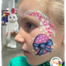 Colourful Easter egg face painting on a child at a Tauranga event
