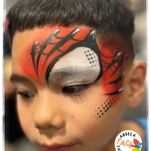 Child with a bold Spiderman face painting design at a Tauranga event